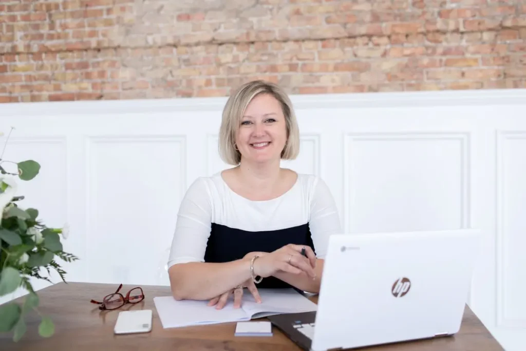 Robin sitting at a desk with laptop in front of her