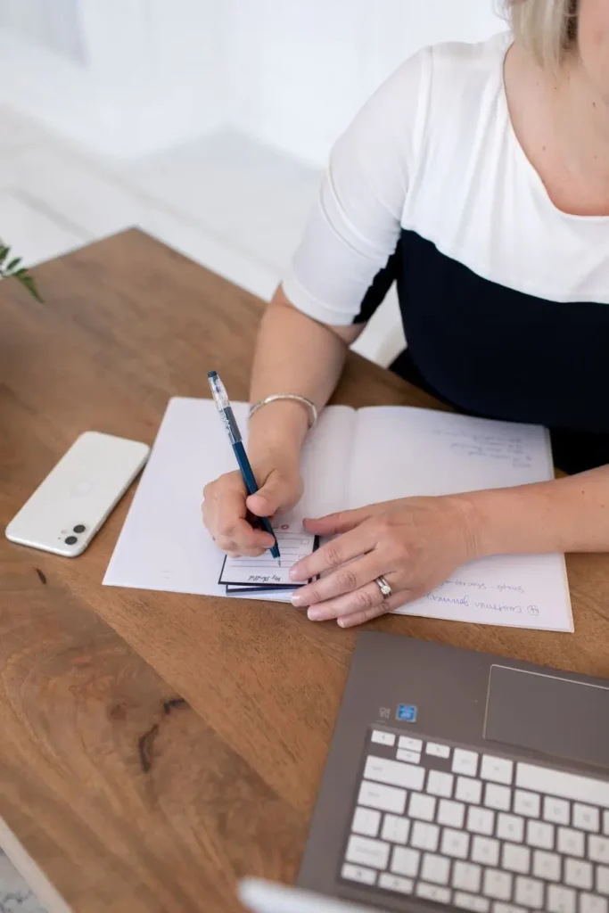 Robin sitting at desk writing in a notbook